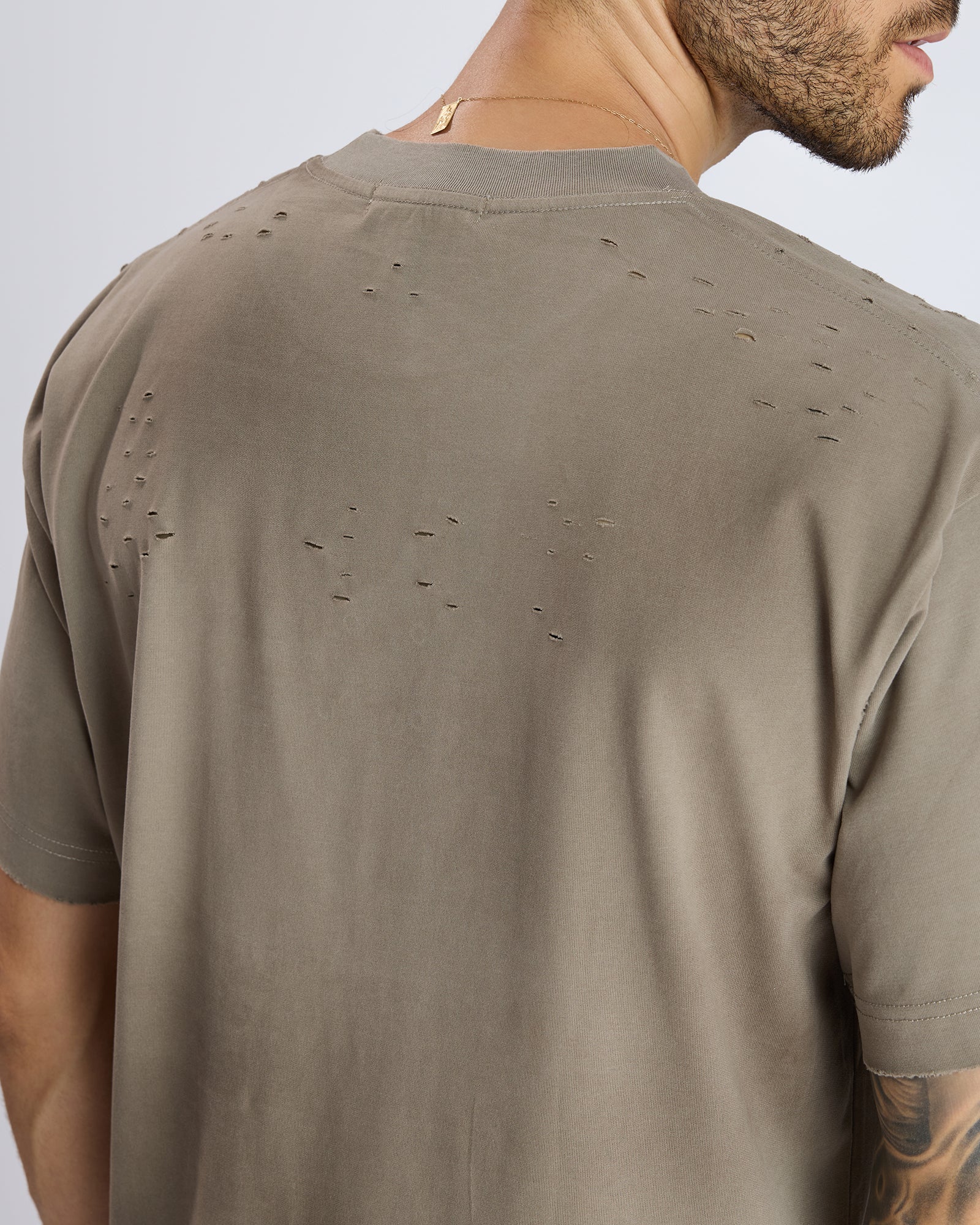 RIPPED T-SHIRT WITH METAL DETAIL